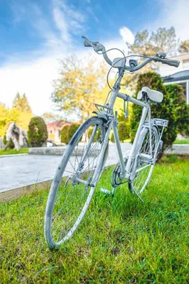 a bike parked in the grass in a yard at Хотел и Вили Марая in Tsarevo