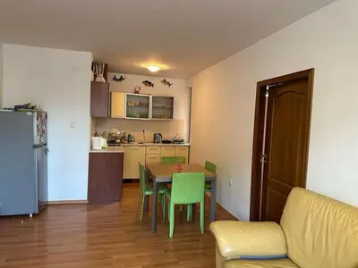 a living room with a table and a kitchen at Tania's Home in Sunny Beach