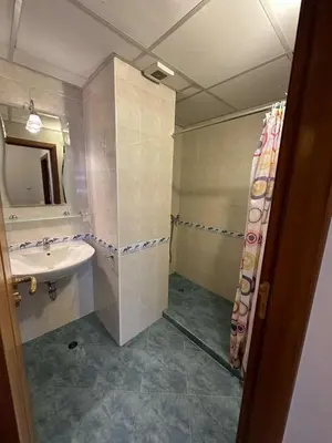 a bathroom with a sink and a toilet and a mirror at Tania's Home in Sunny Beach