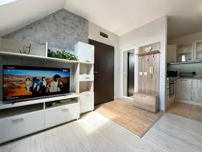 a large white living room with a flat screen tv at Artistic Apartment for 4 Guests in Burgas in Burgas City