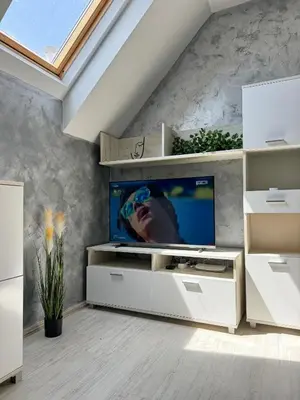 a living room with a flat screen tv on a wall at Artistic Apartment for 4 Guests in Burgas in Burgas City