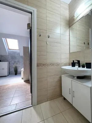a bathroom with a sink and a mirror at Artistic Apartment for 4 Guests in Burgas in Burgas City