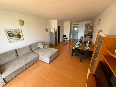 a living room with a couch and a table at Black Pearl Apartment in Sozopol