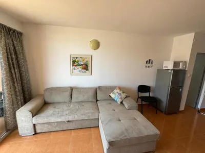 a living room with a couch and a refrigerator at Black Pearl Apartment in Sozopol