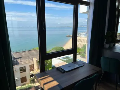 a room with a desk with a view of the ocean at Dolce Vita Premium Apartment Panorama Sea View in Sveti Vlas