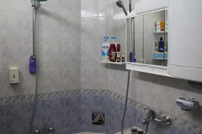 a bathroom with a shower and a sink at Супер апартамент-център Варна in Varna City