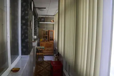 a hallway with green walls and a chair in a room at Супер апартамент-център Варна in Varna City