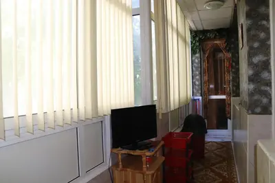 a living room with a television and a table with a tv at Супер апартамент-център Варна in Varna City