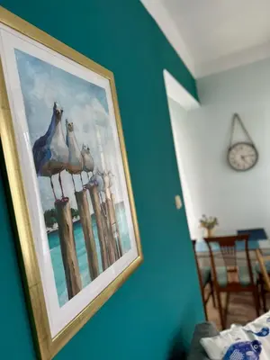 a picture of pigeons on a fence on a wall at Glarus Apartment with Infinity Sea View in Varna City