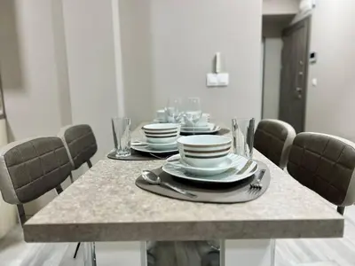 a dining room table with plates and dishes on it at NJ Deluxe rooms in Varna City