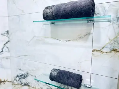 two towels on glass shelves in a bathroom at NJ Deluxe rooms in Varna City