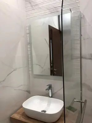 a bathroom with a white sink and a mirror at *HOT* Main Square Brand New Luxury Apartment in Burgas City
