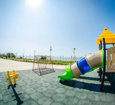 a playground with a water slide and a swing at Premier Lux apartmán in Sveti Vlas
