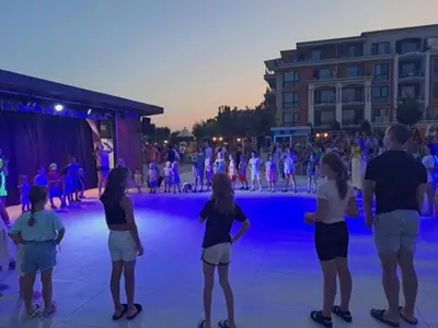 a group of people standing on an ice skating rink at Premier Lux apartmán in Sveti Vlas