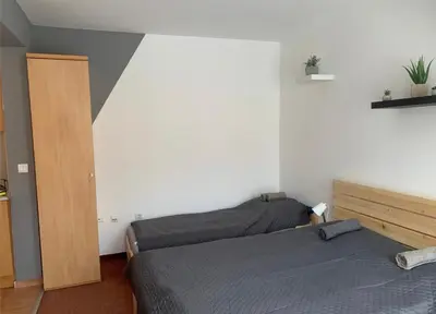 a bedroom with two beds and a closet at Ubytování krásném a klidném prostředí V soukromém apartmánu in Aheloy