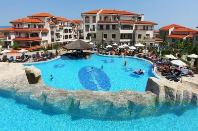 a large swimming pool in a resort with people in it at Scenic, 2 Bedroom Apt with Views in Kableshkovo