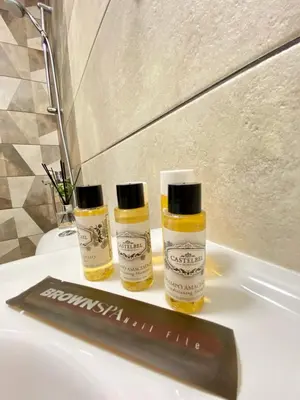two bottles of essential oils sitting on top of a bathroom sink at K&K Sunset in Burgas City