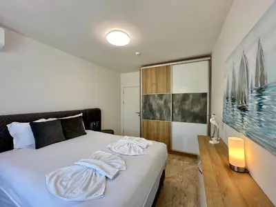 a bedroom with a bed with a towel on it at ONYX 1 - Menada Apartments in Sveti Vlas