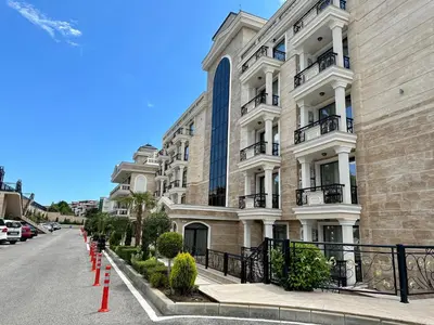 a large white building with red barriers in front of it at ONYX 1 - Menada Apartments in Sveti Vlas