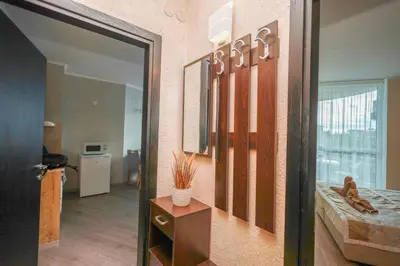 a room with a hallway with a mirror and a table at Sunset Apartment Atlantis Resort in Burgas City