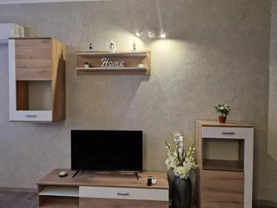 a living room with a television on a table at Sunset Apartment Atlantis Resort in Burgas City