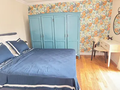 a bedroom with a blue bed and a desk at Anabel Home in Burgas City