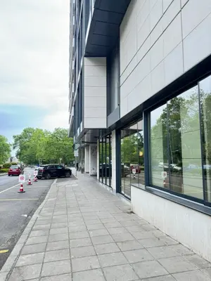 a sidewalk in front of a building with windows at Anabel Home in Burgas City