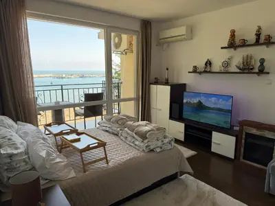 a living room with a view of the ocean at Apartment Porto Chernomoretz in Chernomorets