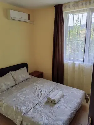 a bedroom with a bed with a towel on it at Apartament Morela in Sunny Beach
