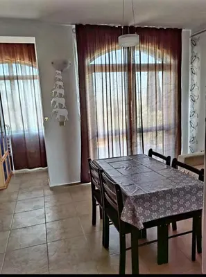 a dining room table and chairs in a room at Apartament Morela in Sunny Beach