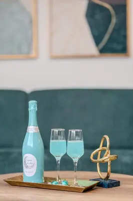 two wine glasses and a bottle on a table at Sea Twins Luxury Aparthotel - 150 m from the beach in Sunny Beach