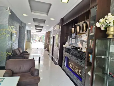 a salon with two chairs and a table in a room at Green Paradise apartman 105 in Primorsko