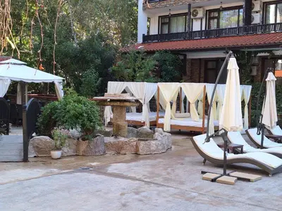 a patio with a table and chairs and umbrellas at Green Paradise apartman 105 in Primorsko