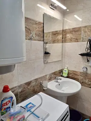 a bathroom with a sink and a toilet and a mirror at Apartment102 Green Paradise Primorsko in Primorsko