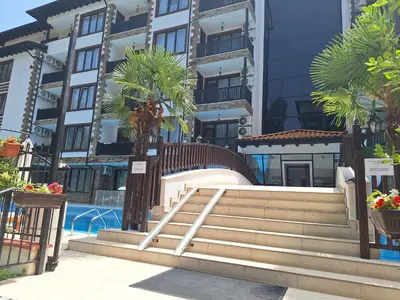 a stairway in front of a building with palm trees at Apartment102 Green Paradise Primorsko in Primorsko