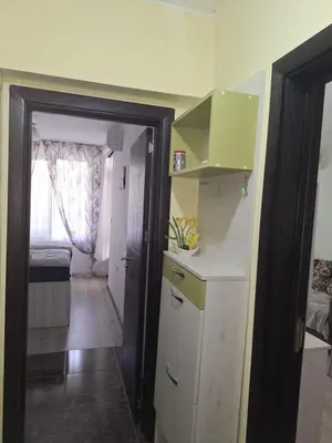 a small kitchen with a white counter and a room at Apartment102 Green Paradise Primorsko in Primorsko