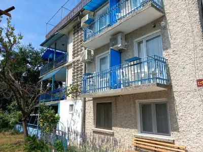 a building with blue balconies on the side of it at Лятна вила Генчеви град Обзор in Obzor