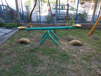 a seesaw in a playground in a park at Лятна вила Генчеви град Обзор in Obzor