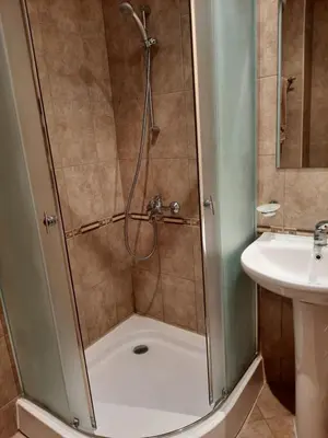 a shower stall in a bathroom with a sink at Апатаменти за гости Sunshine и Glory in Sveti Vlas