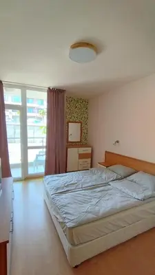 a bedroom with a bed and a large window at Seafront apartment Lucky in Sveti Vlas