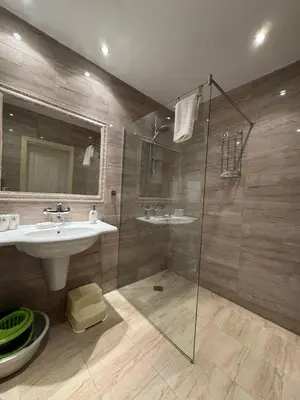 a bathroom with a sink and a glass shower at Marteo Apartments103 - Sozopol in Sozopol