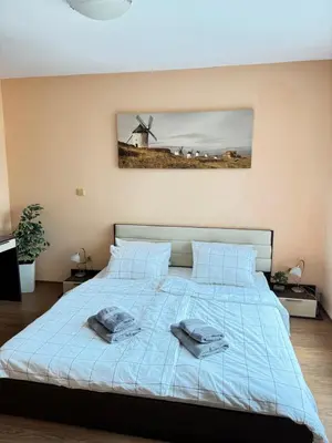 a bedroom with a bed with two towels on it at Stan u moru in Pomorie