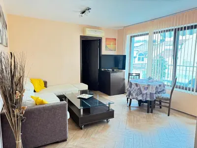 a living room with a couch and a table at Stan u moru in Pomorie