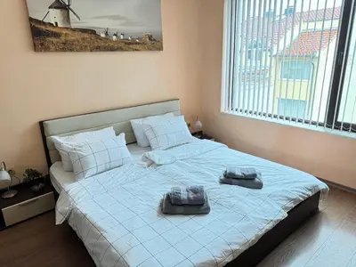 a bedroom with a bed with two towels on it at Stan u moru in Pomorie