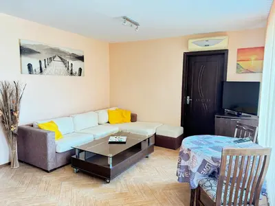 a living room with a couch and a coffee table at Stan u moru in Pomorie