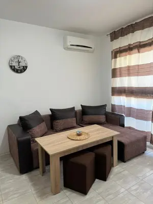 a living room with a couch and a table at Marteo Apartments 105 - Sozopol in Sozopol