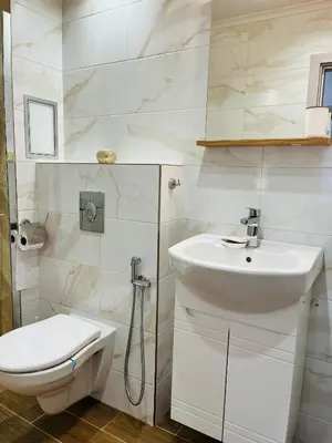 a white bathroom with a sink and a toilet at Boutique Sozopol in Sozopol