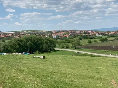 a grassy field with a road in the distance at Brymonte Studio, Sunny Day 6 in Tŭnkovo