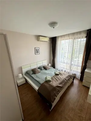 a bedroom with a large bed and a large window at Sea view Prestige Fort beach Apartment in Sveti Vlas