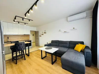 a living room with a couch and a table and a kitchen at CHERNO MORE 107 - 19 APARTMENT Nessebar in Nesebar